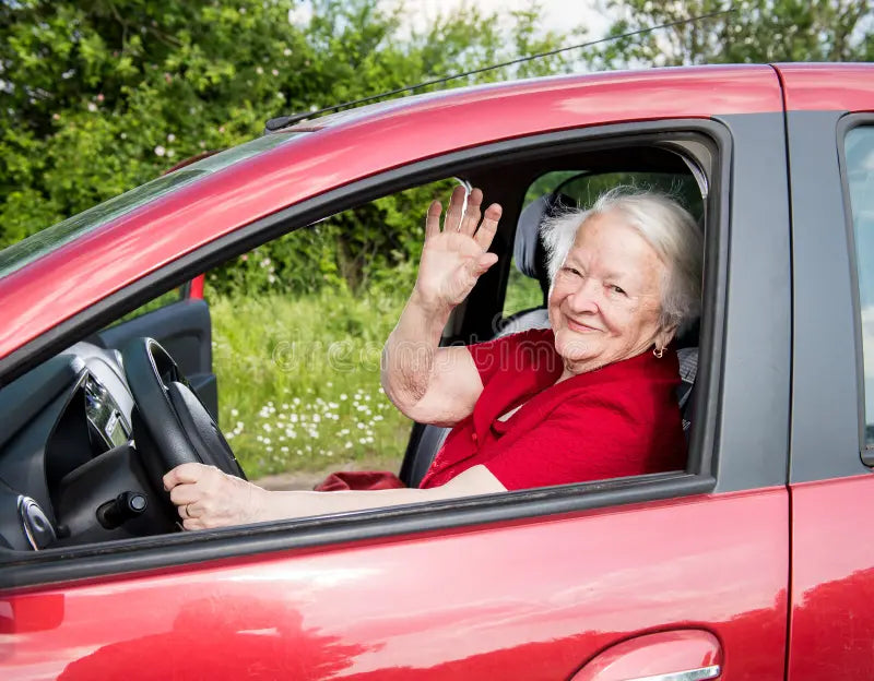 files/smiling-old-woman-sitting-car-inside-54984068.webp